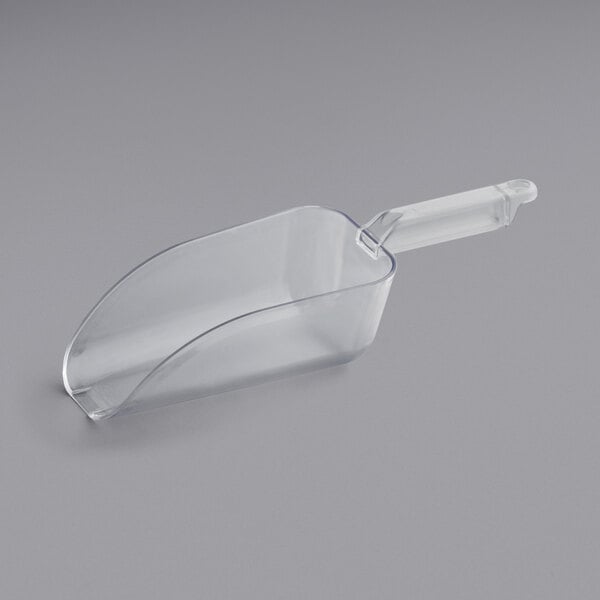 A clear plastic utility scoop with a handle.