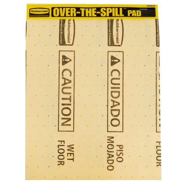 A yellow and black Rubbermaid Over-The-Spill sign on a medium absorbent pad.