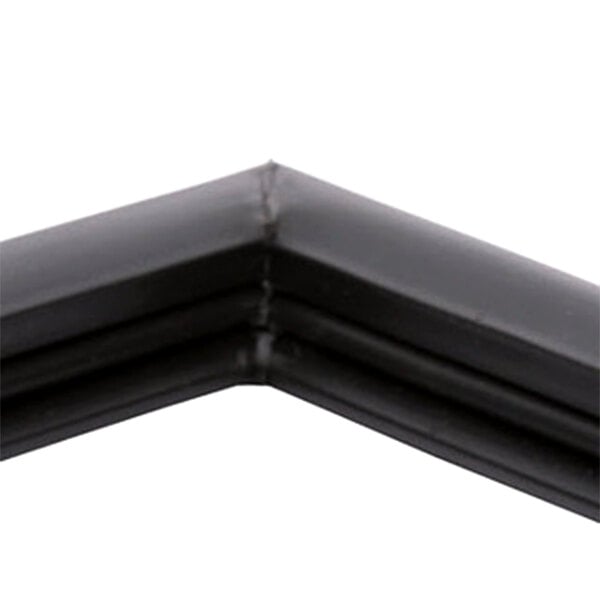 A close up of a black corner piece of a True 810847 equivalent magnetic door gasket.