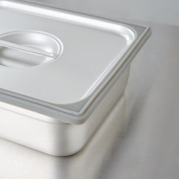 A gray silicone band on a stainless steel steam table pan.