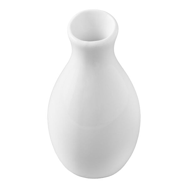 A small, white, ceramic jug vase with a rounded body and narrow neck.