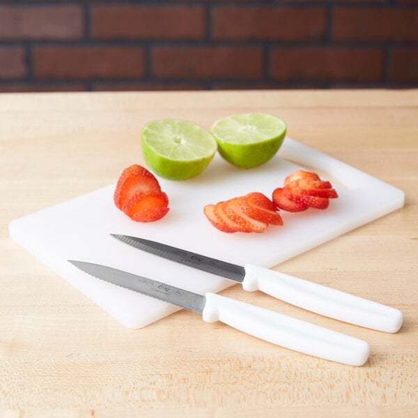 A Choice white bar size cutting board with a knife and a lime on it.