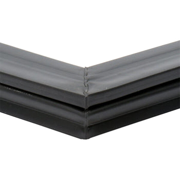 A close-up of a black plastic magnetic door gasket corner.