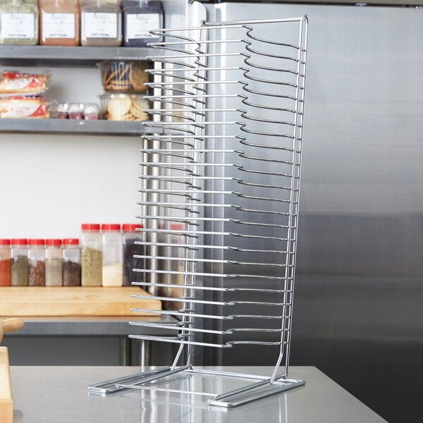 An American Metalcraft stainless steel pizza pan rack on a counter.