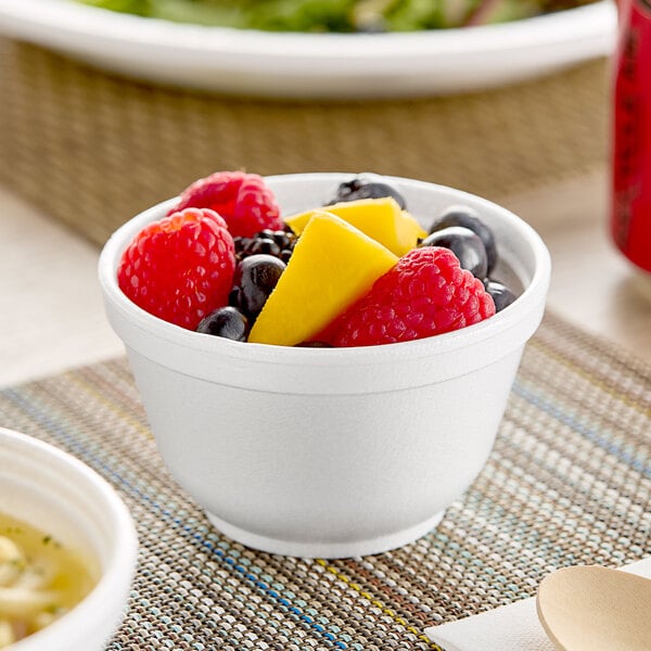 A close-up of a bowl of soup in a white Dart foam bowl.