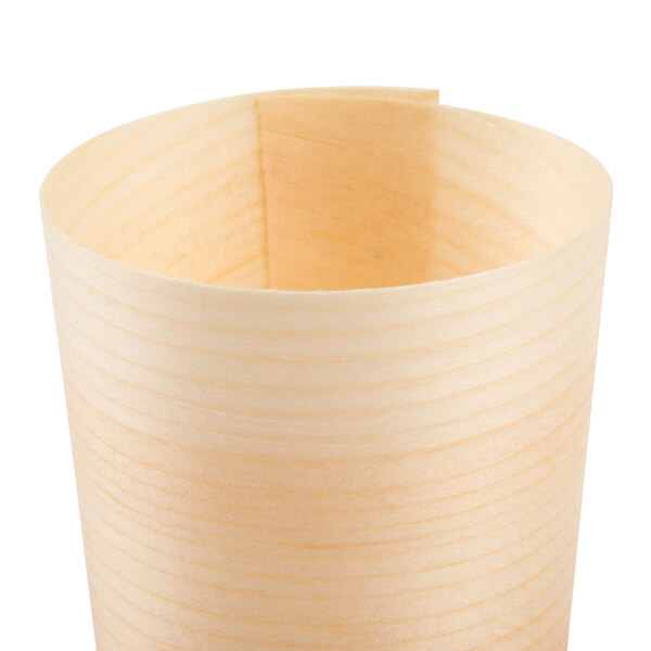 A close-up of a Tablecraft mini wooden serving cup with a curved surface.