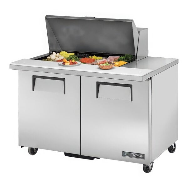 A True 48 3/8" Mega Top Refrigerated Sandwich Prep Table with Two Doors on a counter.