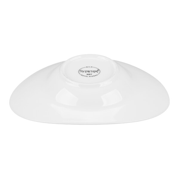 A white porcelain dish shown upside down with a visible maker's mark on the bottom.
