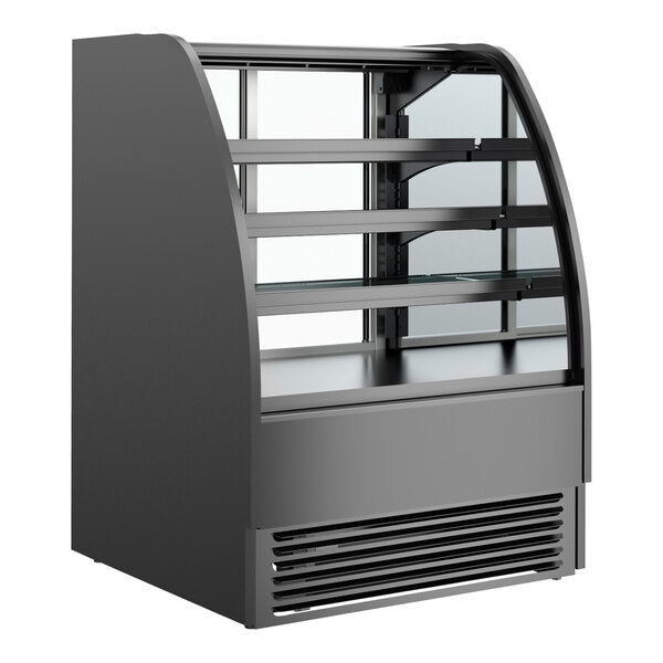 A black Structural Concepts refrigerated bakery display case with curved glass shelves.