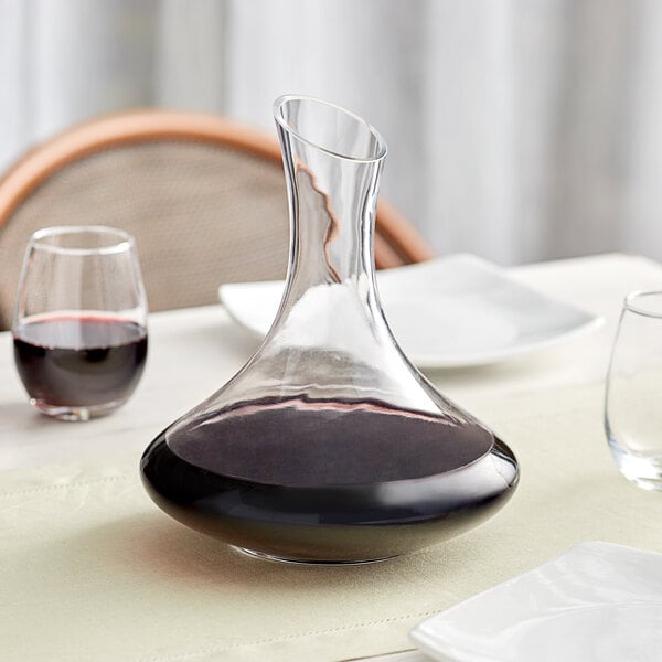 a medium bowl wine decanter with red wine inside