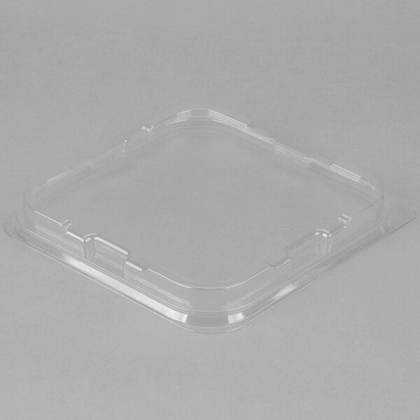 A Solut clear plastic low dome lid on a clear plastic container.