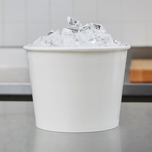 A white Lavex disposable paper ice bucket filled with ice on a counter.