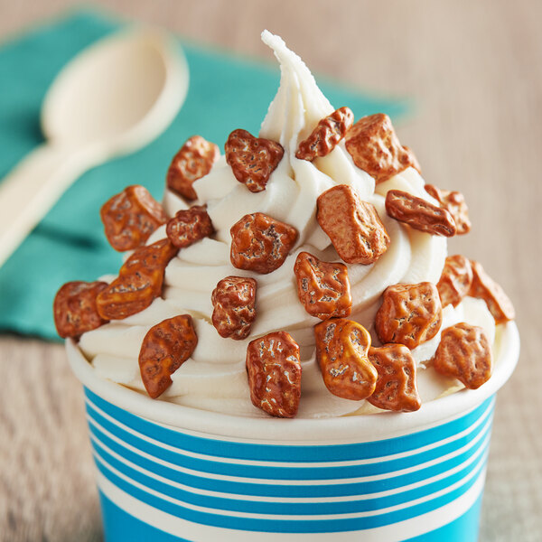 A cup of ice cream topped with Salted Caramel Chocolate Rocks.