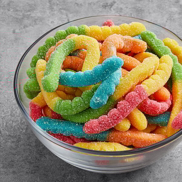 A bowl of colorful Albanese Large Sour Neon Gummi Worms.