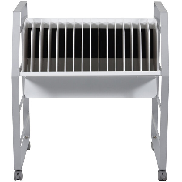 A white metal rack with black and white stripes holding a Luxor open charging cart with tablets and Chromebooks on it.