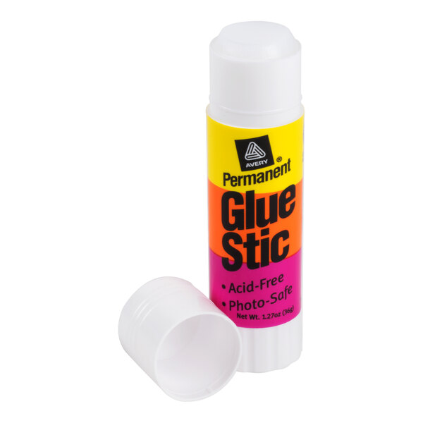 A white glue stick with a colorful label and a detached cap placed beside it.