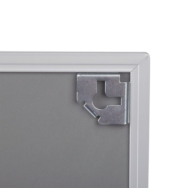 The metal corner of a Universal white melamine dry erase board.