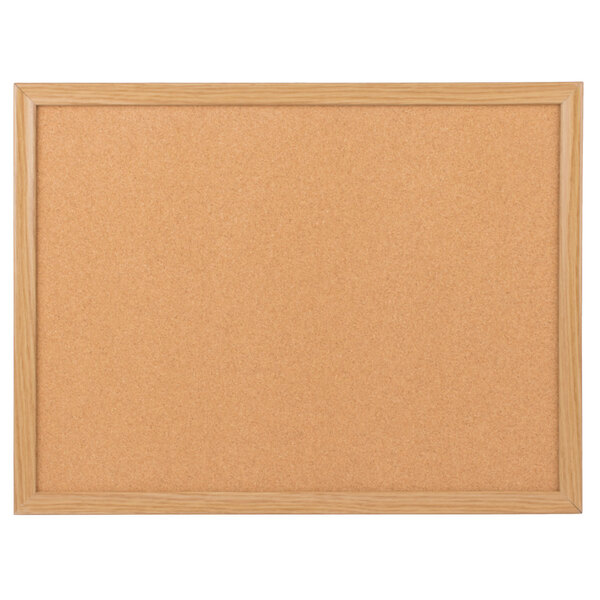 A cork board with a wooden frame.