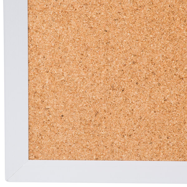 A Universal cork board with a white frame.