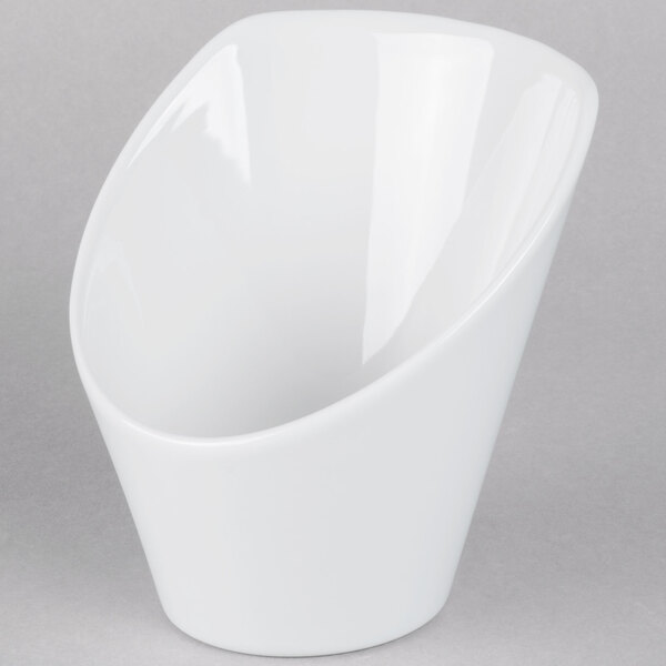 A Tuxton bright white china bowl with a high back and a curved edge.