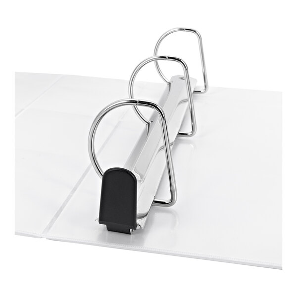 A white binder with three large metal slant rings and a plastic end cap, shown open on a flat surface.
