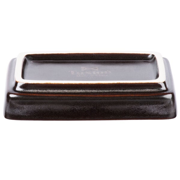 A rectangular Tuxton China sauce dish in black and white.