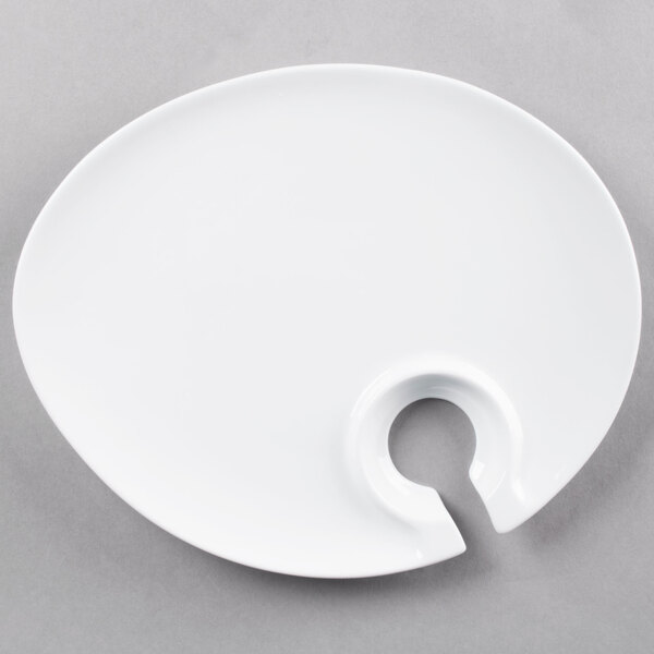 A white Tuxton TuxTrendz appetizer plate with a hole in the middle.