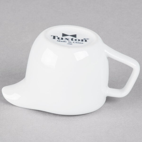 A Tuxton bright white china creamer with a handle.