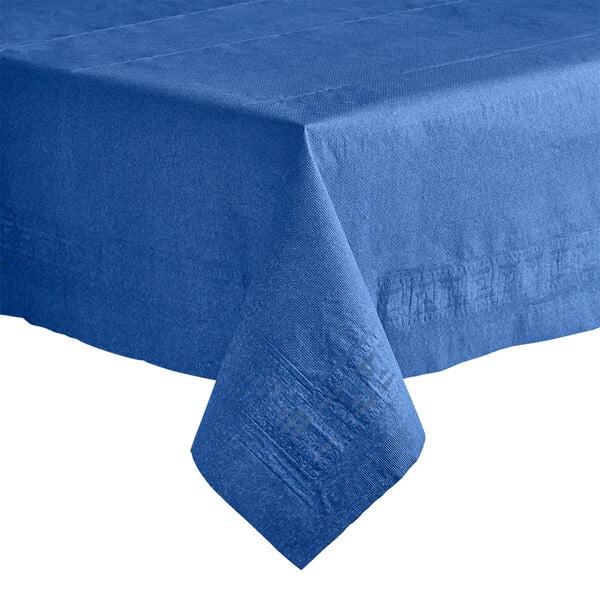 A navy blue Hoffmaster Cellutex table cover on a table with a folded edge.