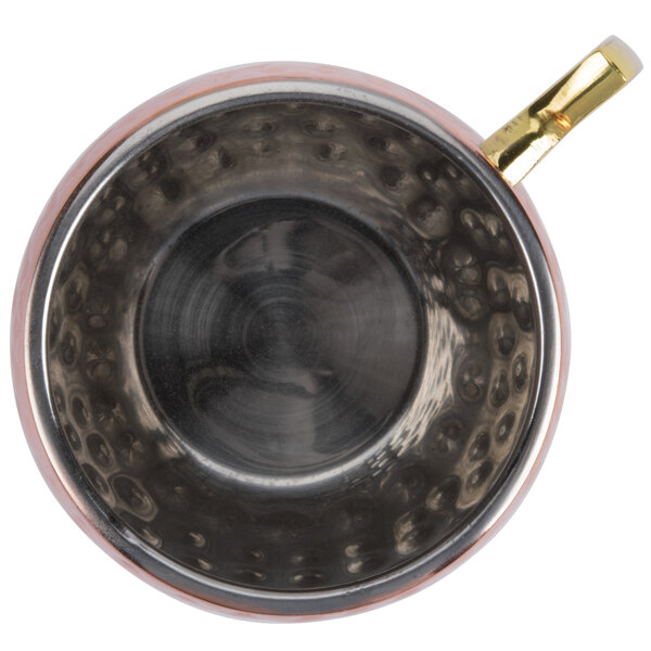 An American Metalcraft hammered copper Moscow Mule mug with a gold handle.
