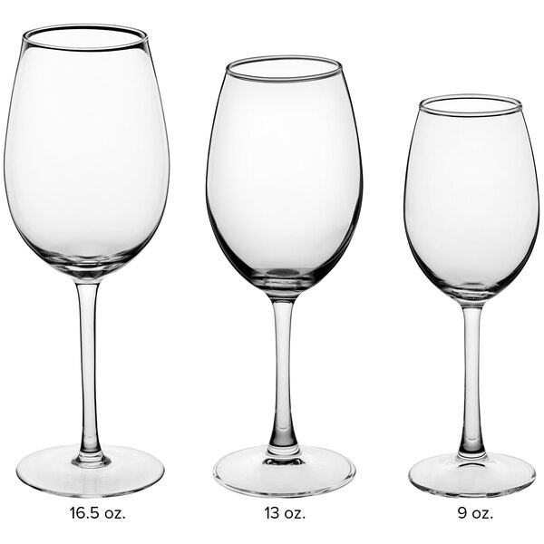 A close-up of three Acopa Select Blanc wine glasses.