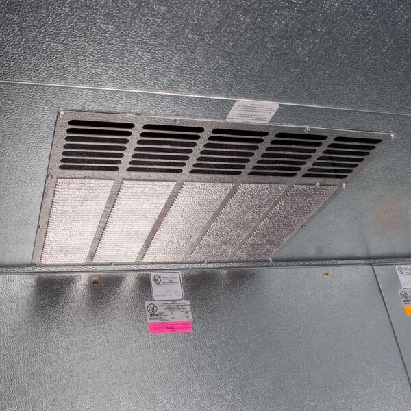 A metal vent in the interior of a Norlake walk-in cooler.