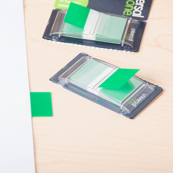 A green paper flag in a plastic dispenser.
