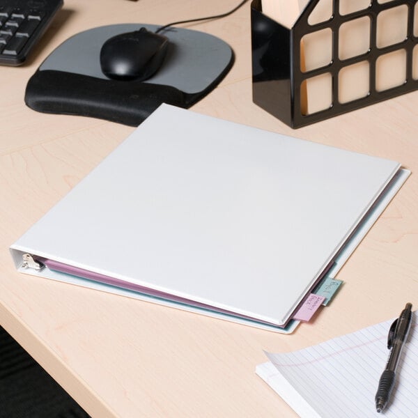 A Universal white deluxe non-stick view binder on a desk.