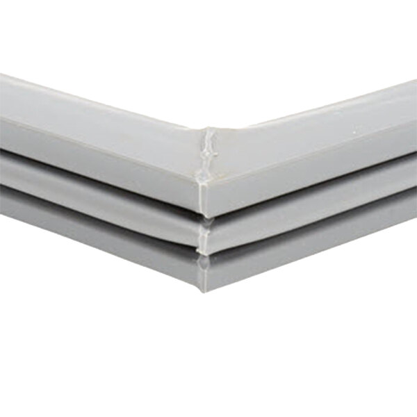 A close-up of a gray plastic corner of a white Delfield door gasket.