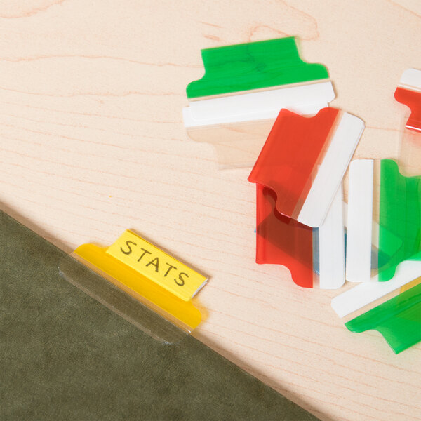 A group of colorful Avery Plastic Index Tabs on a table.