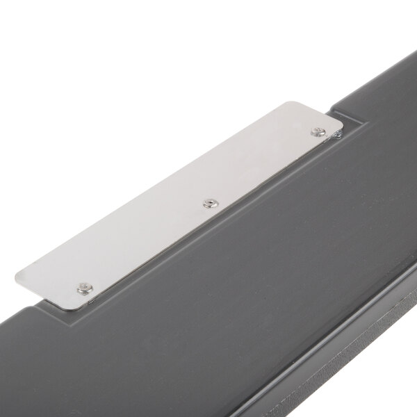 A close-up of a metal edge with a metal plate.