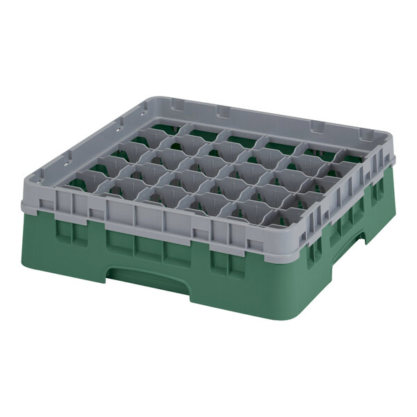 A green and grey plastic container with several compartments and holes.