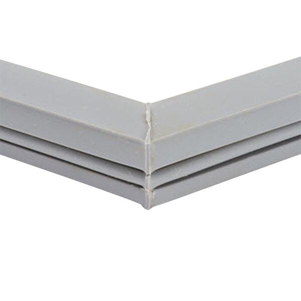 A close up of a gray corner piece of a Delfield equivalent door gasket.