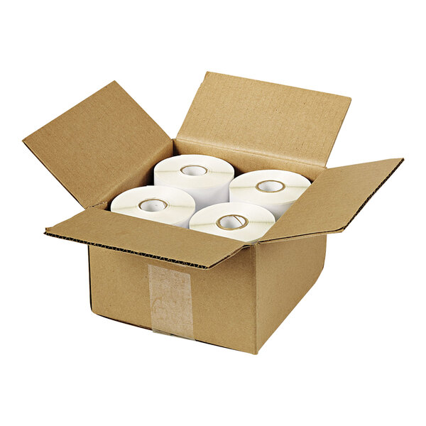 An open cardboard box containing four rolls of white thermal labels.