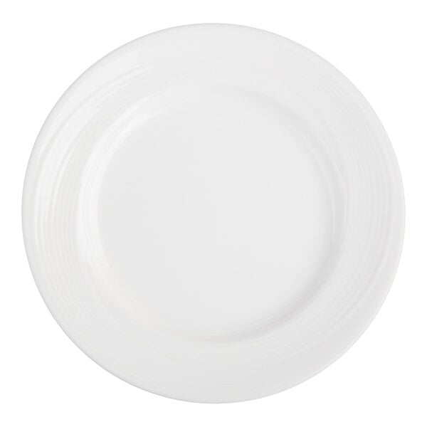 A plain white round plate with a wide rim and subtle concentric circular patterns.