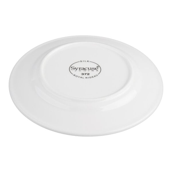 A white porcelain plate shown upside down, displaying the manufacturer's mark and product information on the bottom.