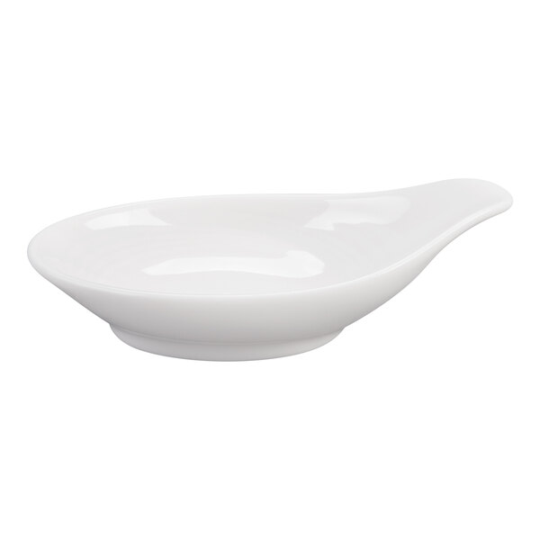 A white, shallow, oval-shaped porcelain dish with a small handle-like extension on one end.