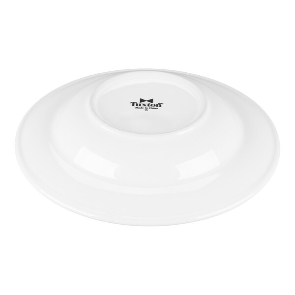 A white Tuxton China soup/pasta bowl with a black rim.
