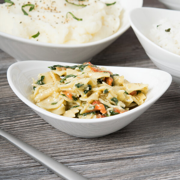 A white porcelain bowl filled with pasta and mashed potatoes.