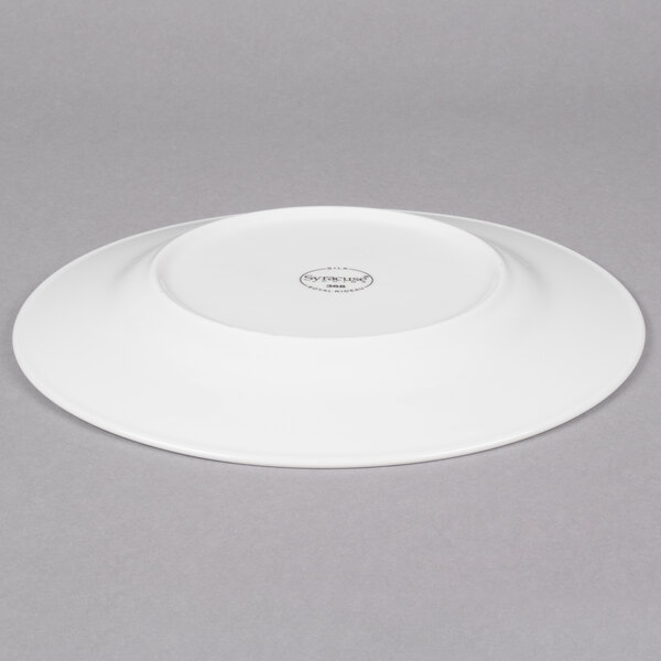 A white Reserve by Libbey Silk porcelain plate with a wide circular rim.