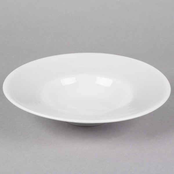 A Reserve by Libbey white porcelain pasta bowl with a wide rim.