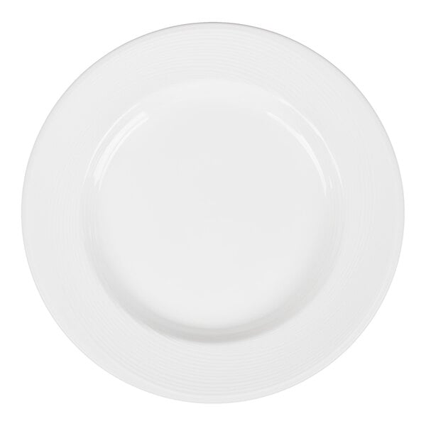 A plain white round plate with a wide rim and subtle concentric line detailing near the edge.