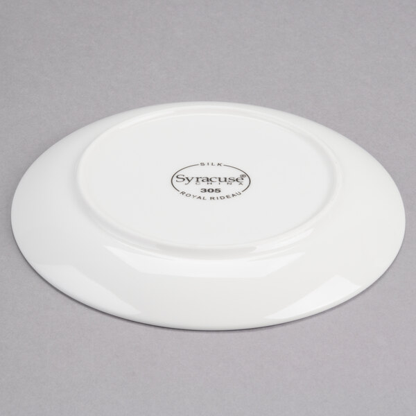 A white Reserve by Libbey Royal Rideau porcelain coupe plate with a small black logo.