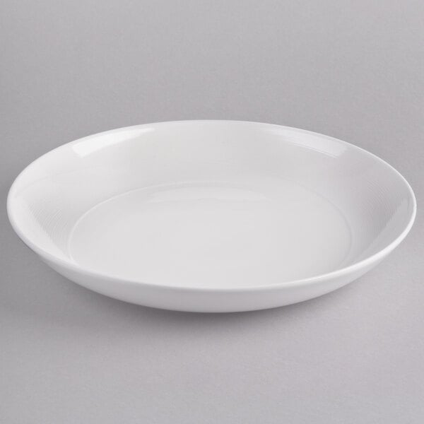 A white bowl on a gray surface.